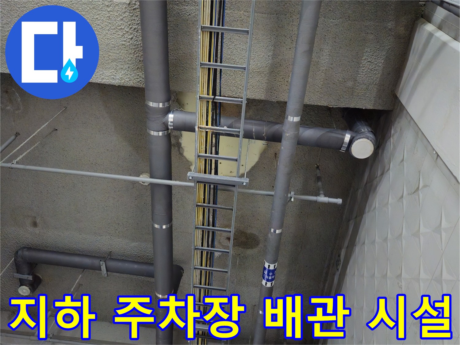 복잡하게 얽힌 지하 주차장의 배수 배관과 전선 케이블 트레이 구조물