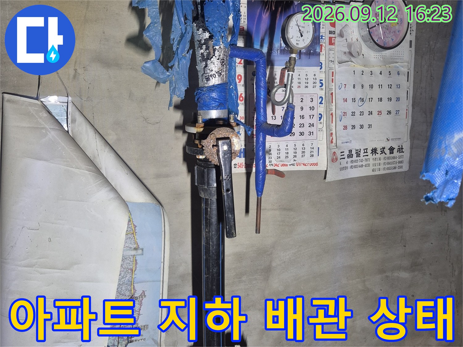 파란색 보온재로 마감된 아파트 지하 급수용 배관과 계량기 장치